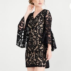 Black/nude lace cocktail dress with bell sleeves.